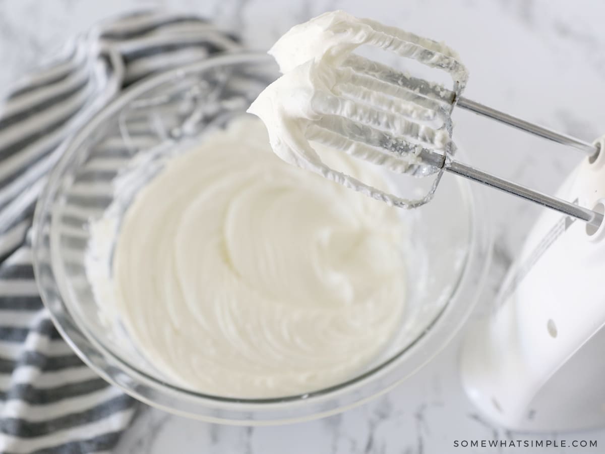 adding cream and flavoring to frosting