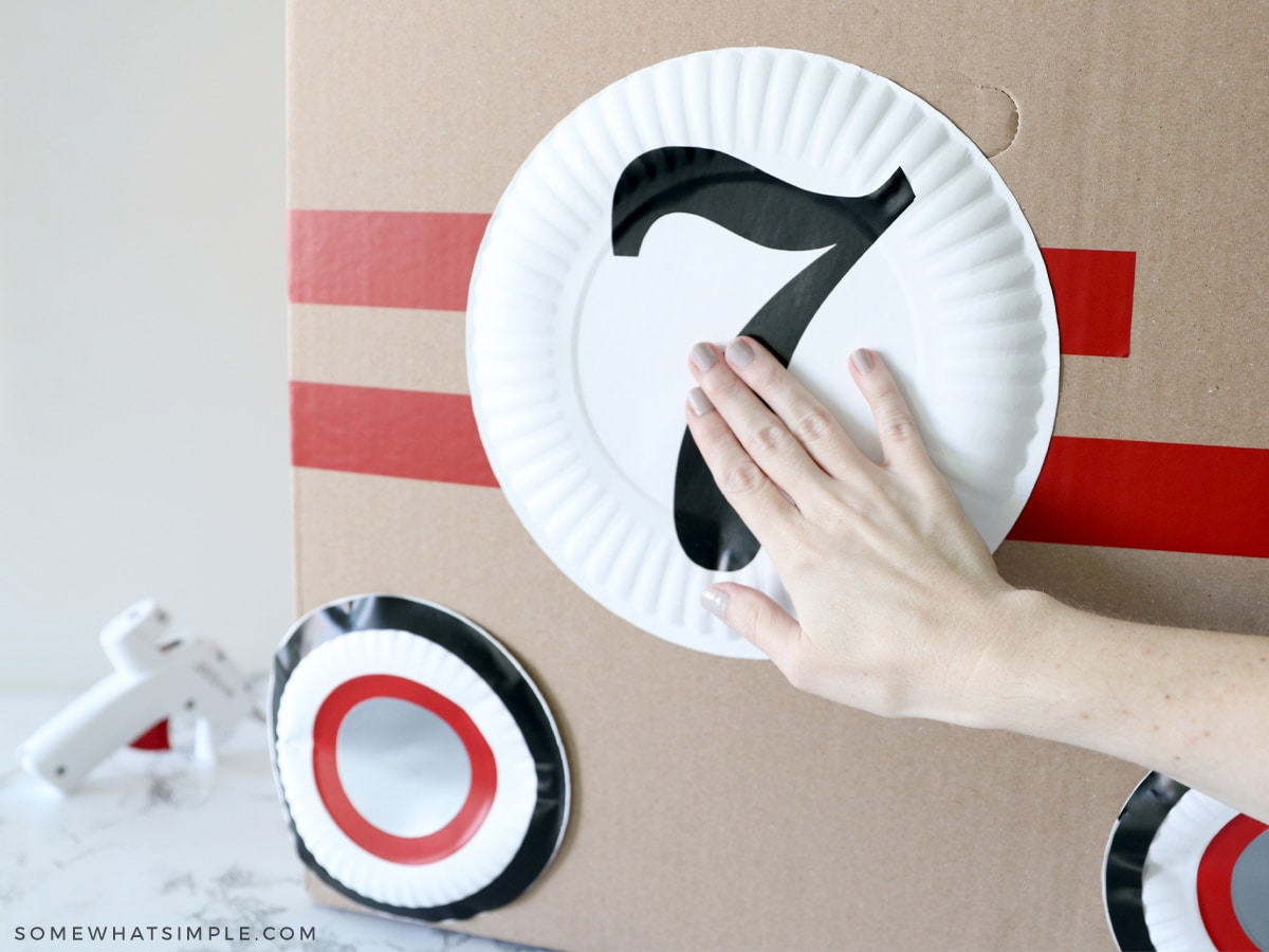 adding embellishments to a cardboard racing car