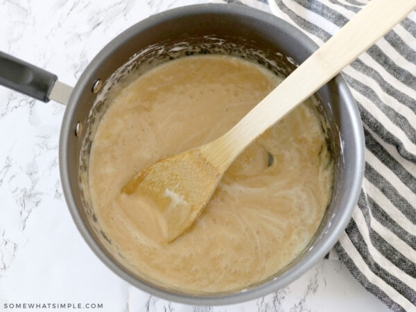 adding peanut butter to a sauce pan