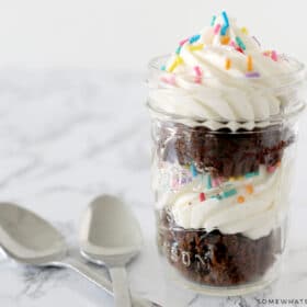 cupcake in a jar next to two spoons