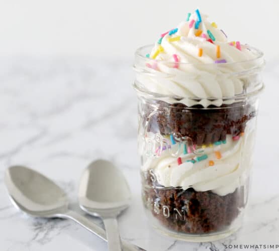 cupcake in a jar next to two spoons