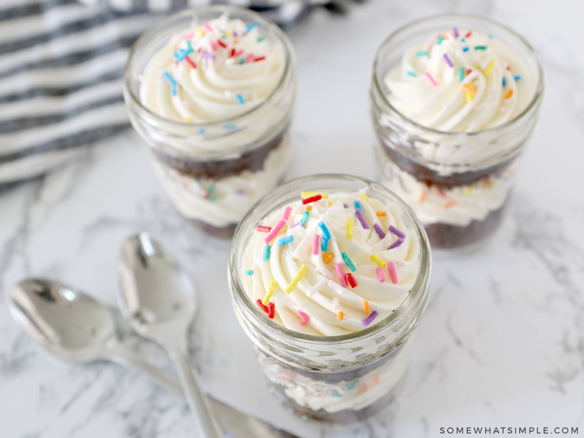 top shot looking down into mason jars filled with cupcakes and frosting