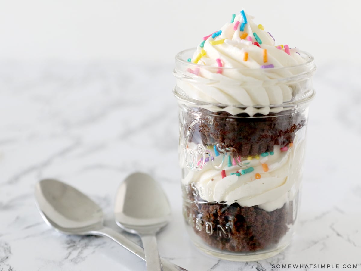 cupcake in a jar next to two spoons