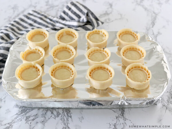 filling ice cream cones with cake batter