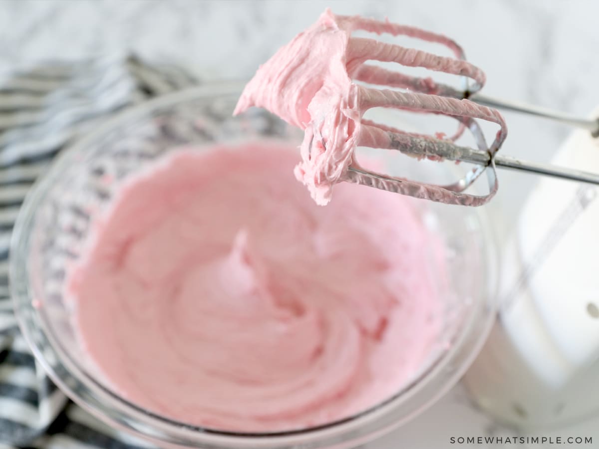 buttercream froting being mixed with a hand mixer