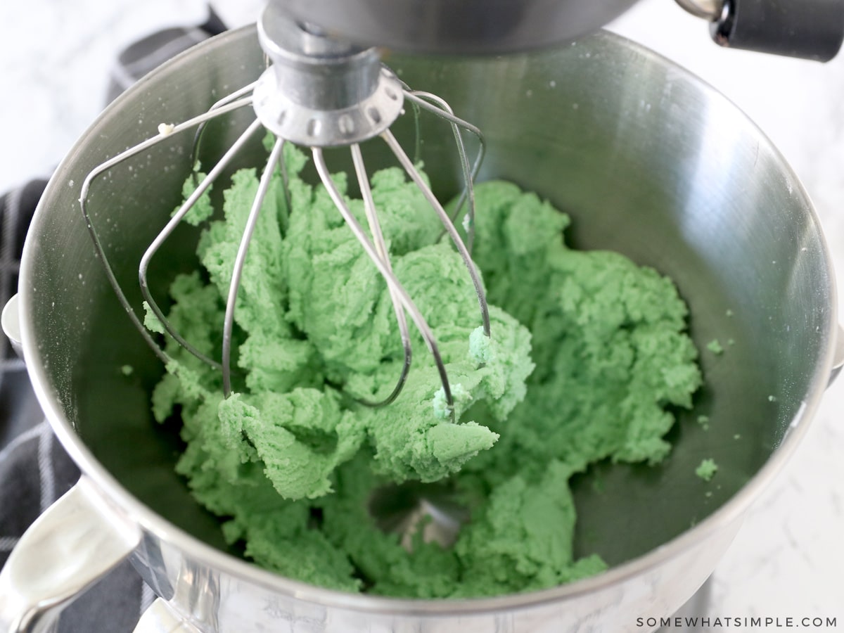 adding green food coloring to cookie dough