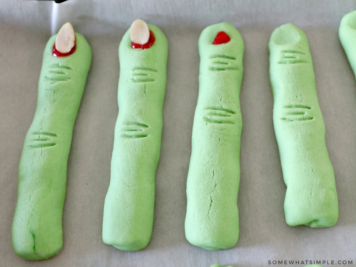 adding red gel to witch finger cookies