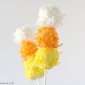 2 sticks with candy corn marshmallows on them