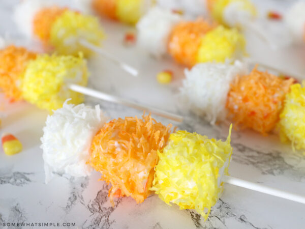 chocolate covered marshmallows in candy corn colors on lollipop sticks