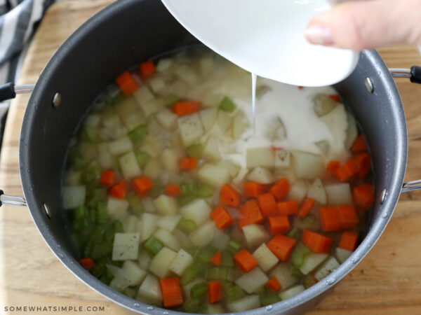 adding the roux to the pot of soup