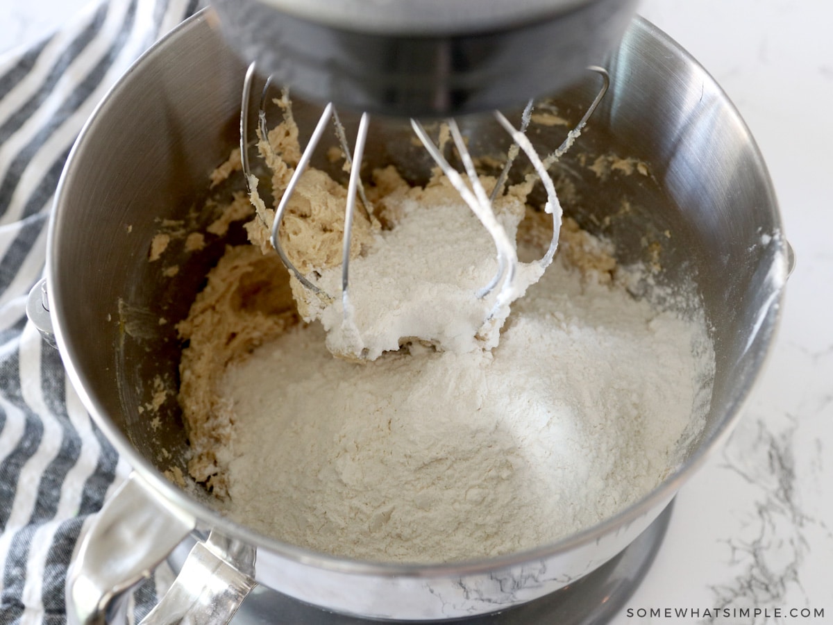 adding dry ingredients to wet ingredients to make cookies