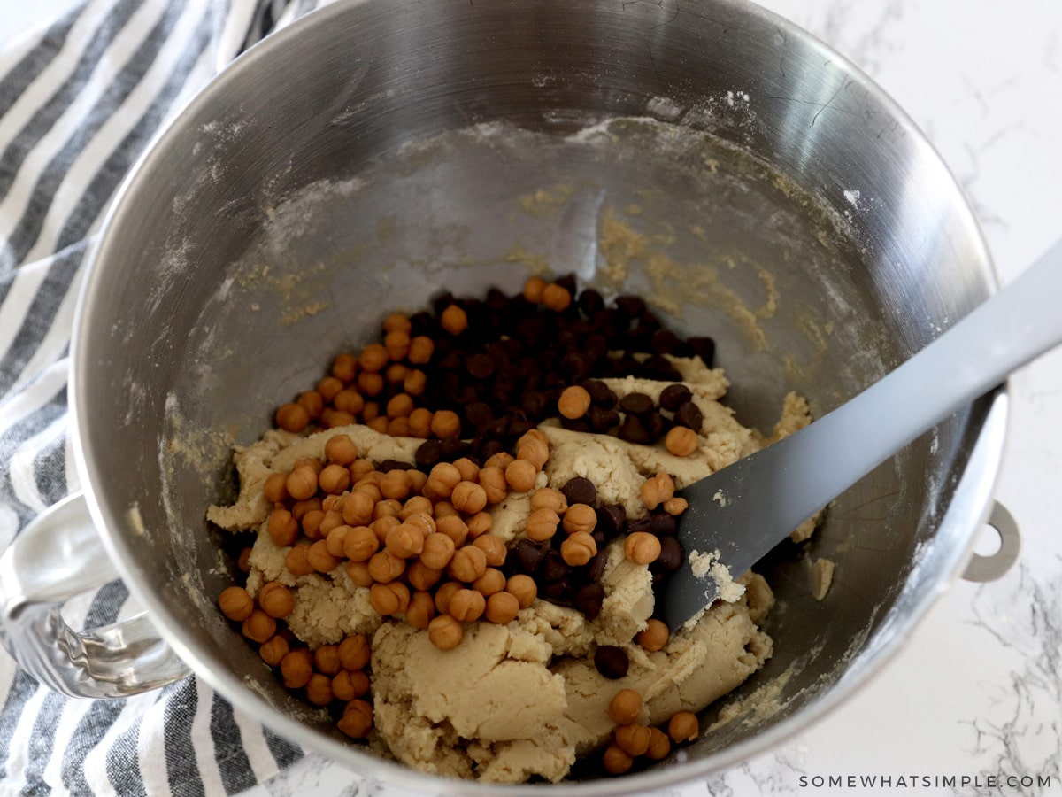 adding chocolate chips and caramel cookies