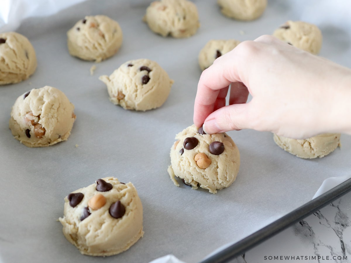 pressing chocolate chips to the tops of cookies