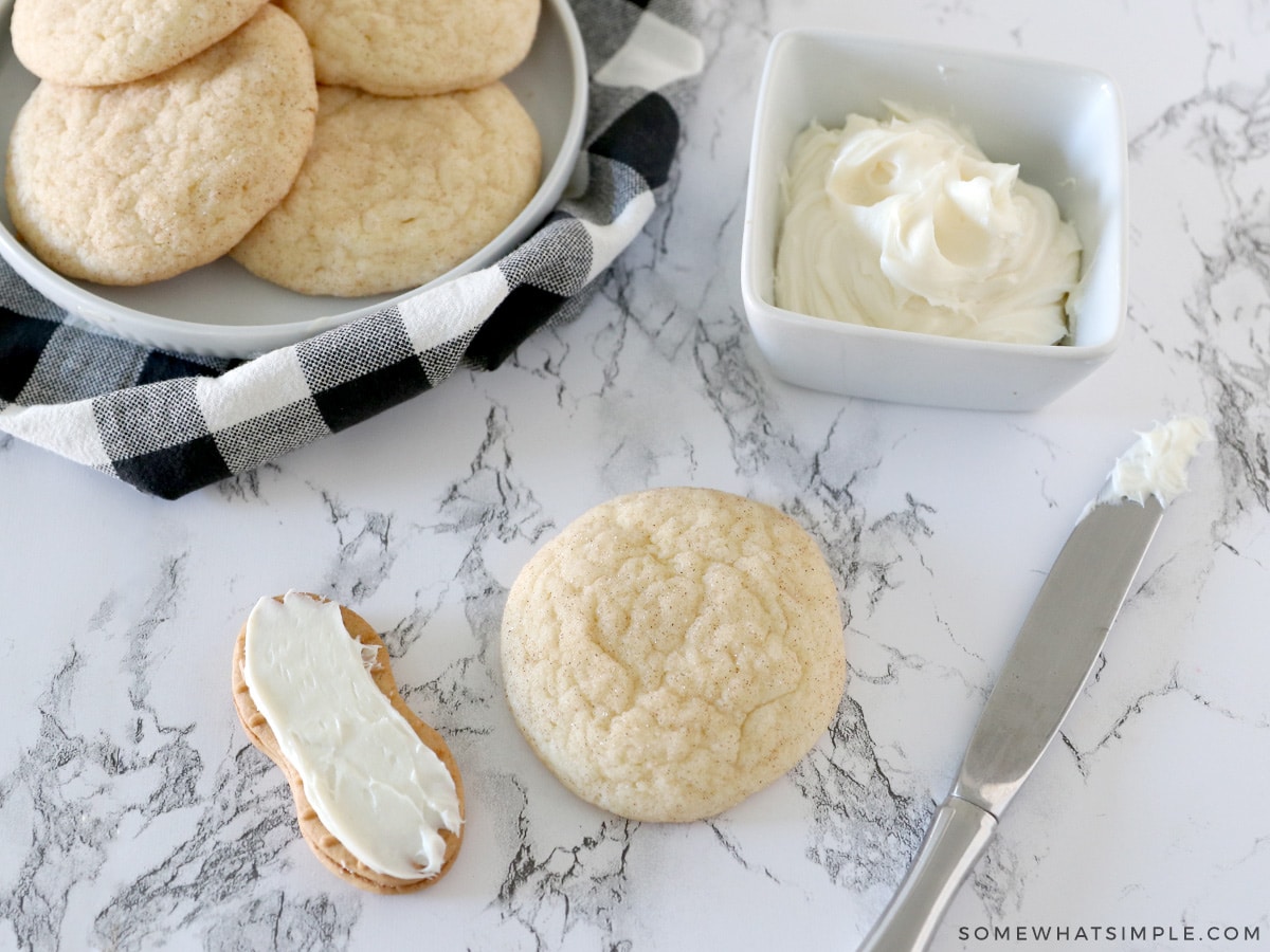 putting frosting on the back of a nutter butter cookie so it sticks to a round snickerdoodle