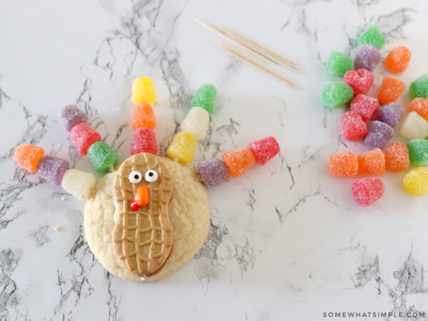 adding gumdrops to toothpicks to make turkey feathers