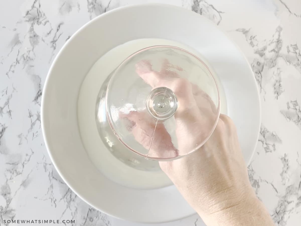 dipping a margarita glass onto a plate of milk