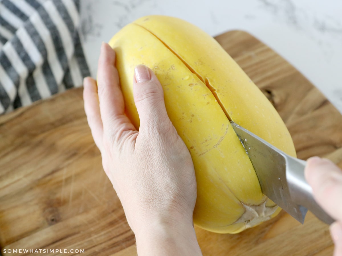 cutting into a spaghetti squash on it's side