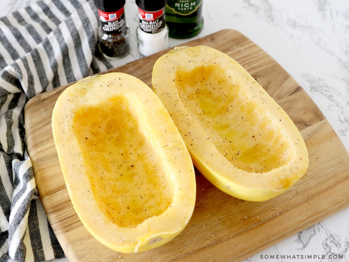 adding oil and salt and pepper to a spaghetti squash