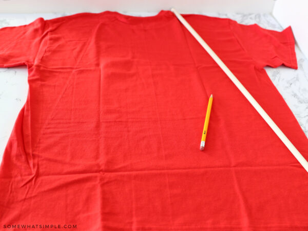 cutting a red t shirt into a superhero cape