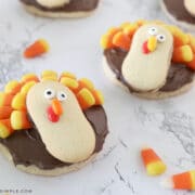 turkey cookies made with sugar cookies, chocolate frosting, milano cookies, and candy corn
