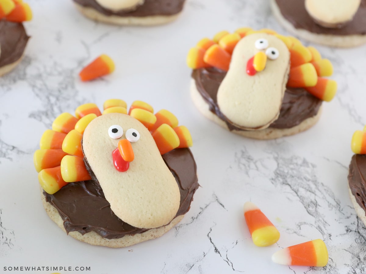 turkey cookies made with sugar cookies, chocolate frosting, milano cookies, and candy corn