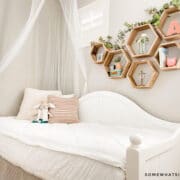 girls bedroom with white bedding and light pink pillows
