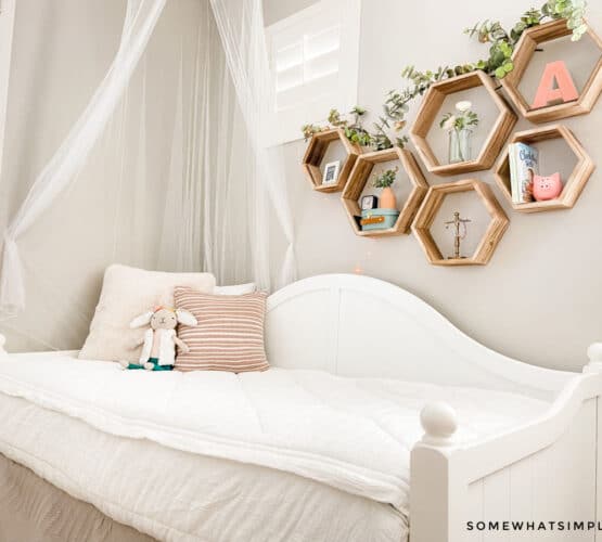 girls bedroom with white bedding and light pink pillows