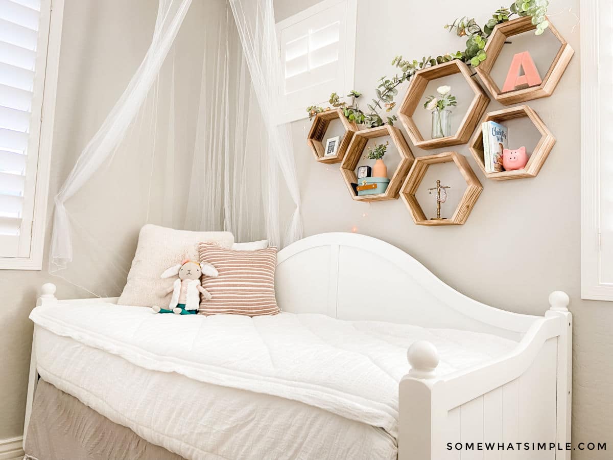 girls bedroom with white bedding and light pink pillows