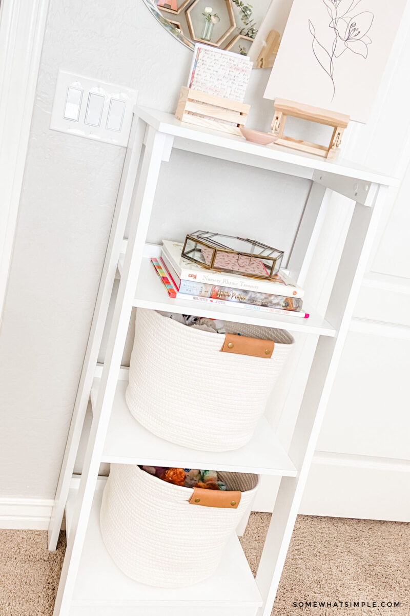 white bookshelf with baskets and girls bedroom deor