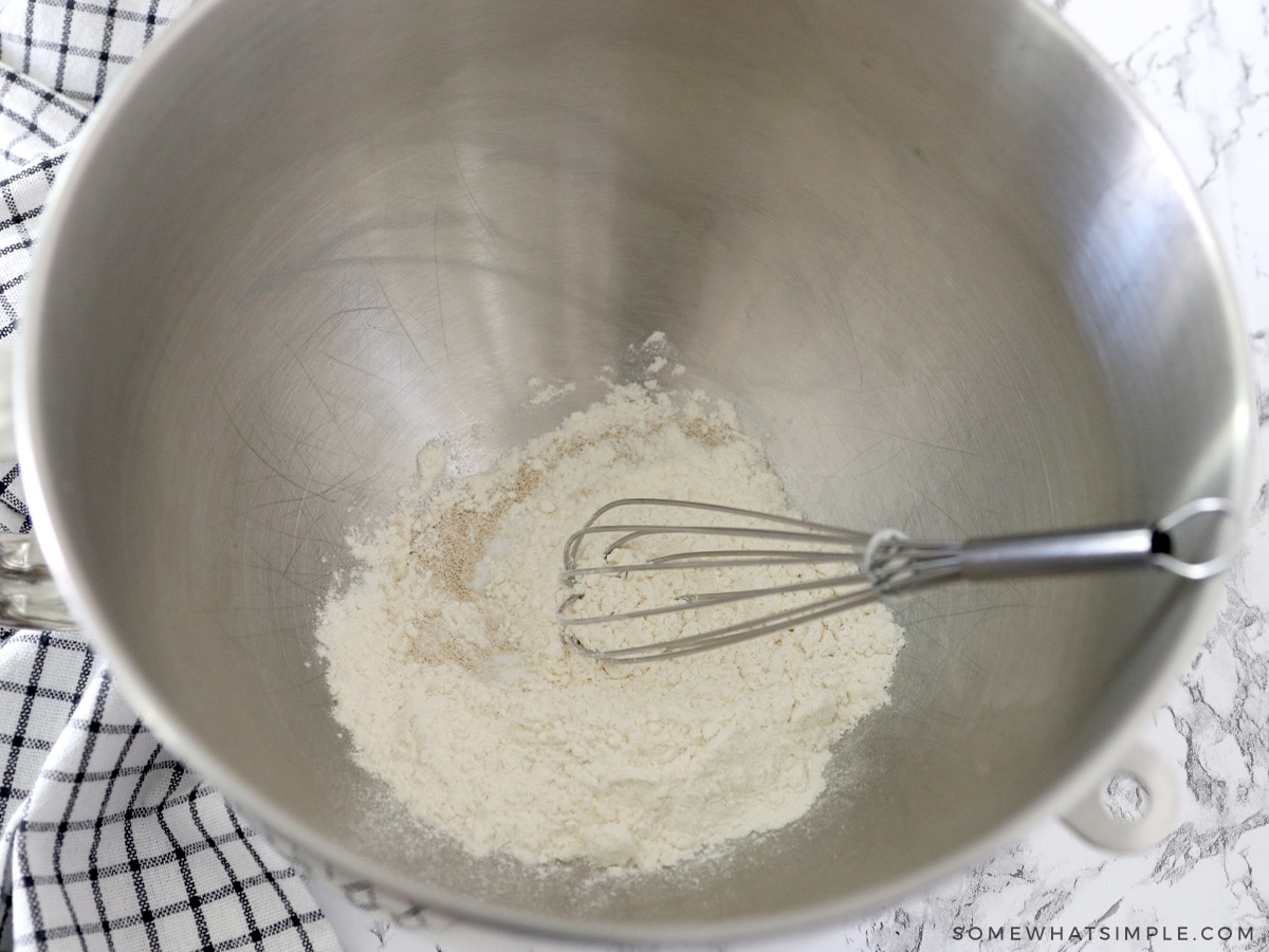 whisking dry ingredients in a metal bowl