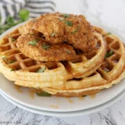 chicken and waffles on white plates