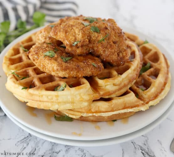 chicken and waffles on white plates