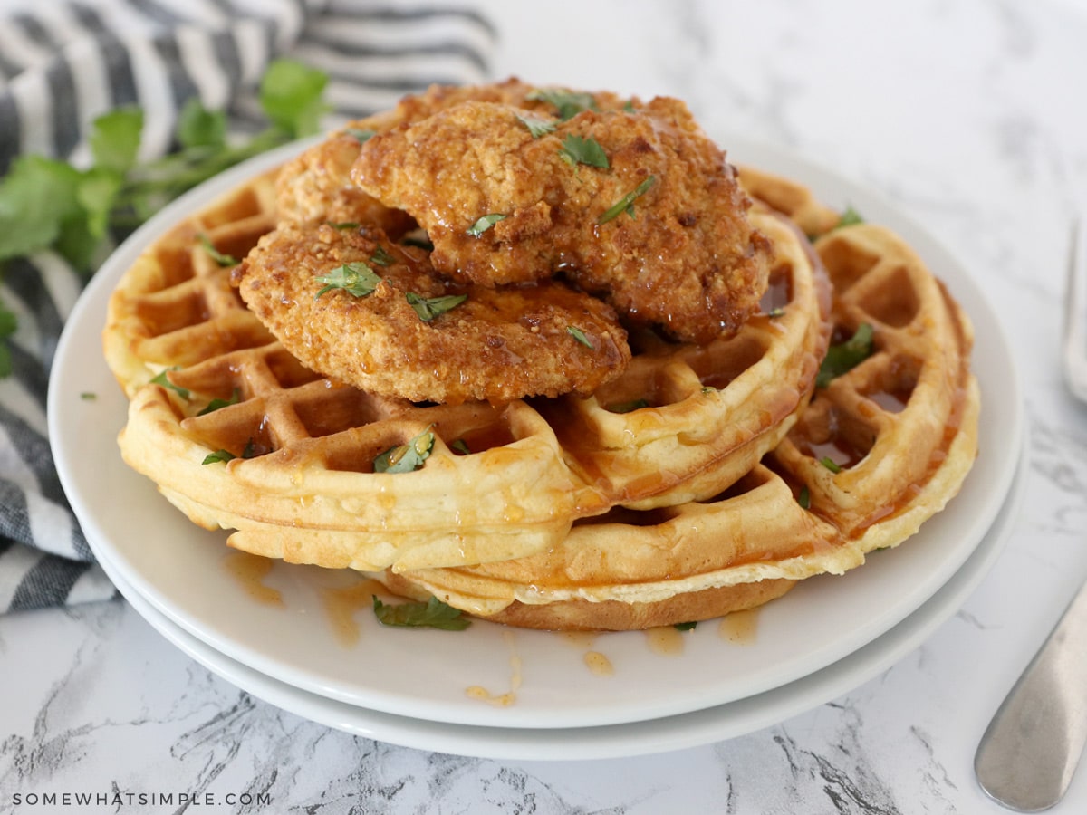 chicken and waffles on white plates