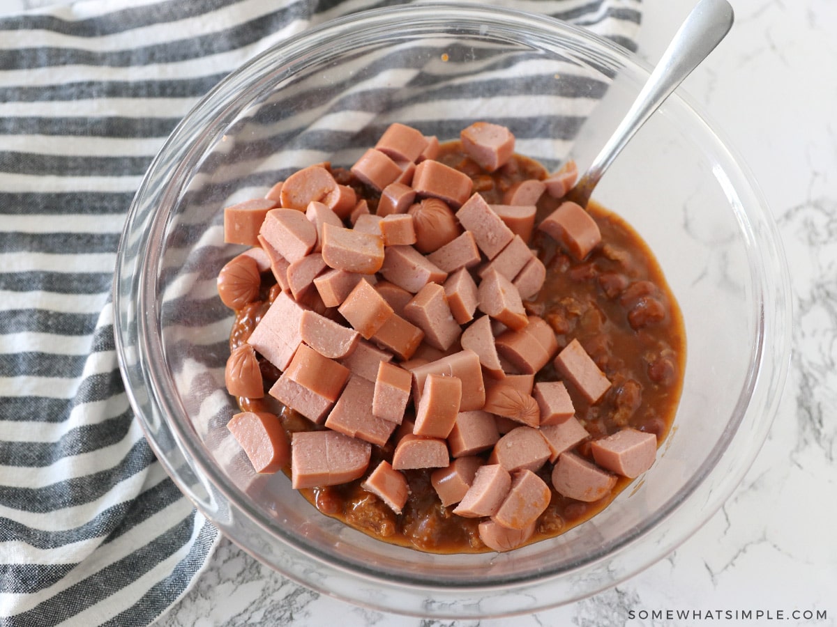 mixing hot dogs with chili