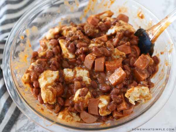 mixing ingredients of a chili cheese dog