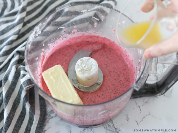 adding butter to a food processor with cranberries