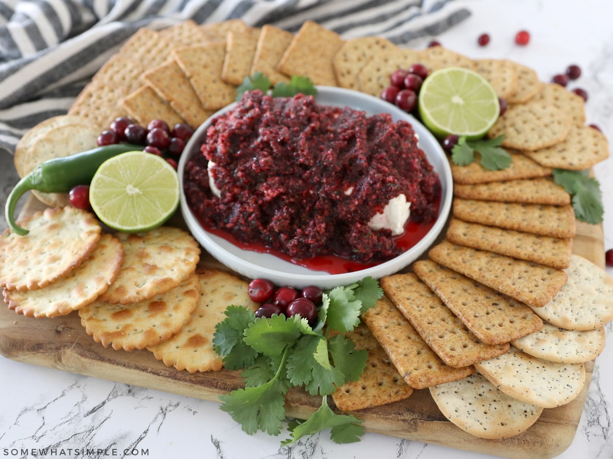 cranberry salsa surrounded by a plate of crackers