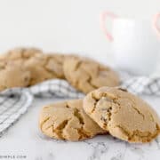 big, soft gingersnap cookies with mugs of hot cocoa in the back
