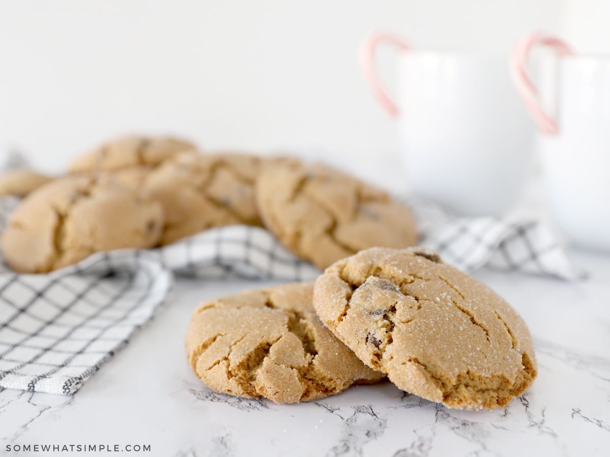 big, soft gingersnap cookies with mugs of hot cocoa in the back