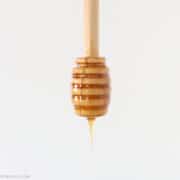 hot honey dripping off a wooden honey spoon