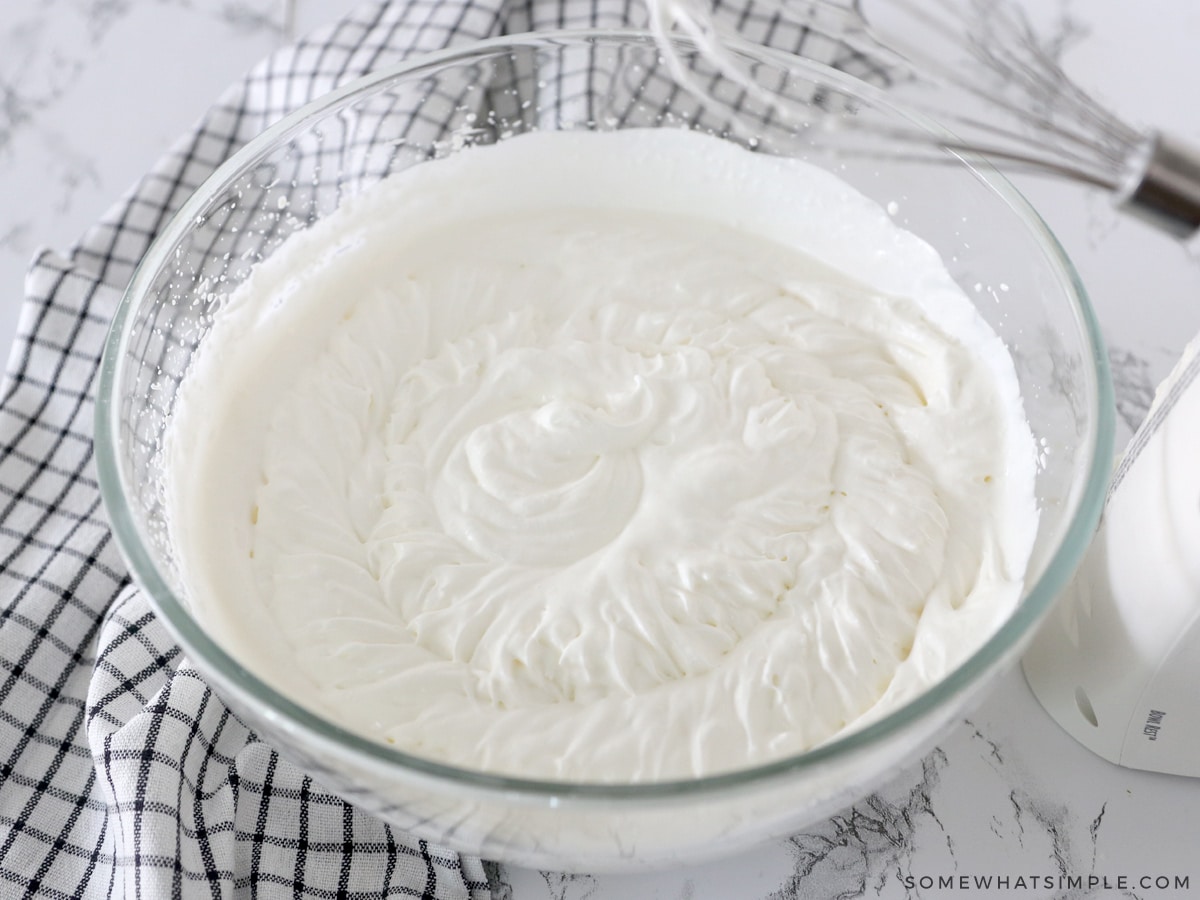 mixing whipped cream in a glass bowl