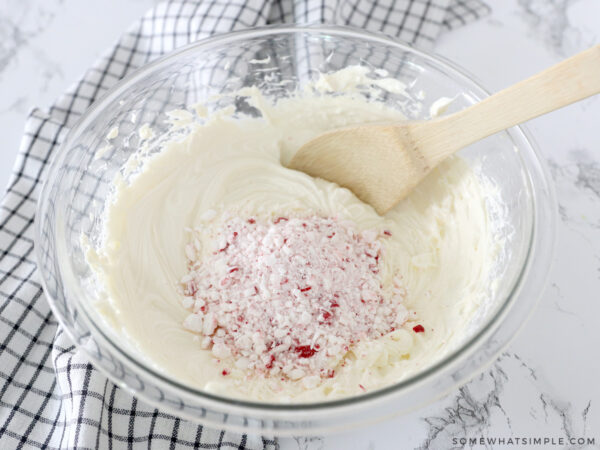 mixing peppermint cheesecake with crushed peppermint