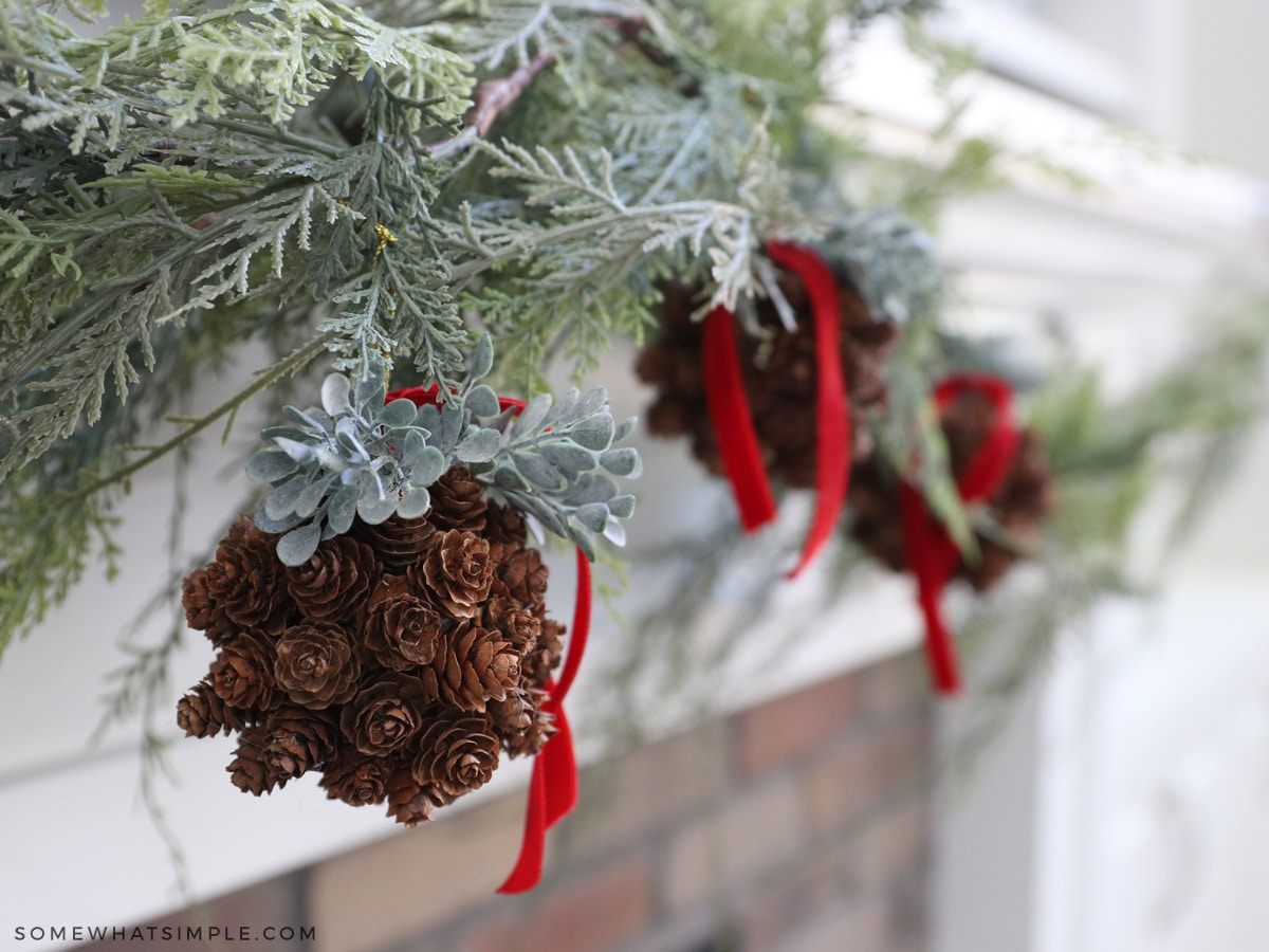 pinecone topiaries hanging on a garland