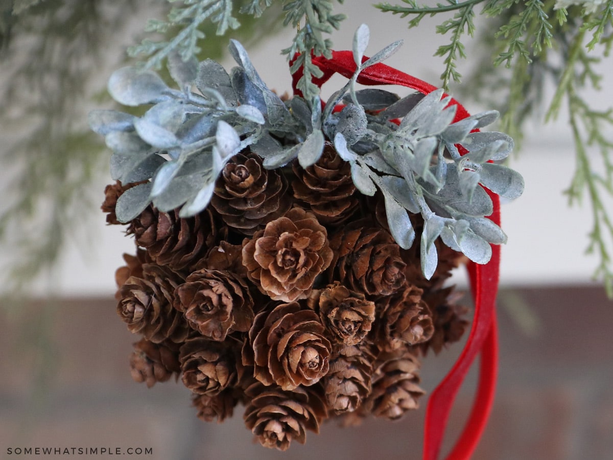 pinecone topiary ball hanging on a garland