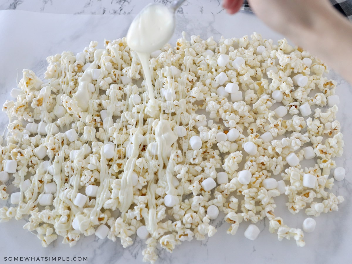 spreading popcorn onto wax paper