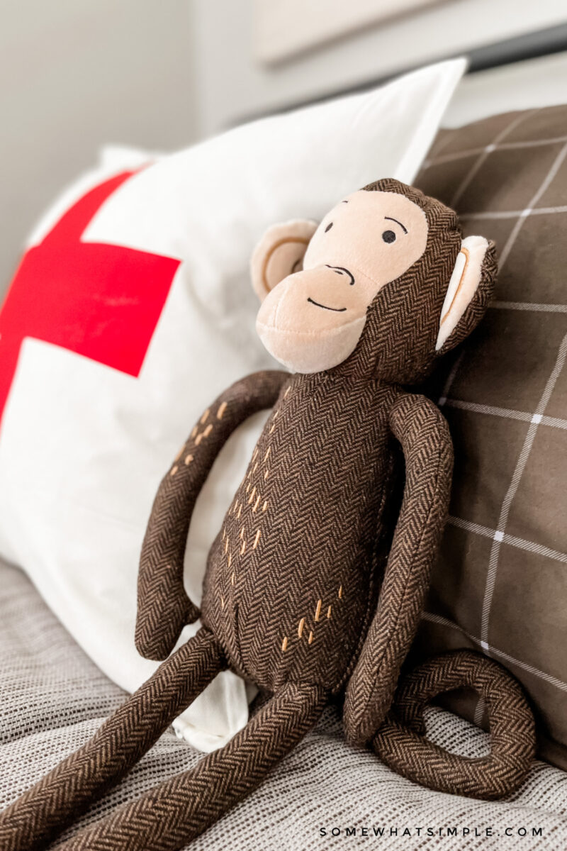 close up of a stuffed monkey on a bed