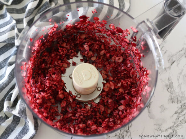 Finely chopping cranberries in a food processor.