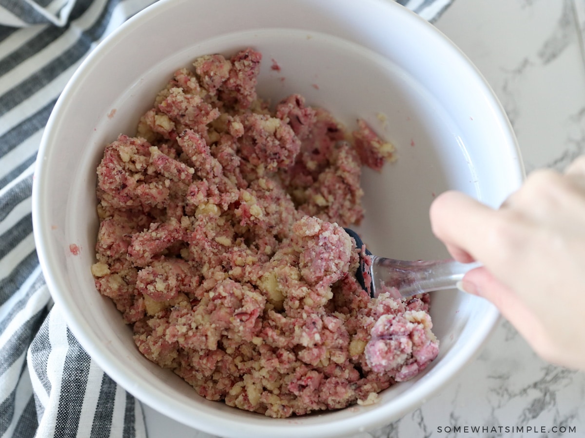 hand mixing cranberries