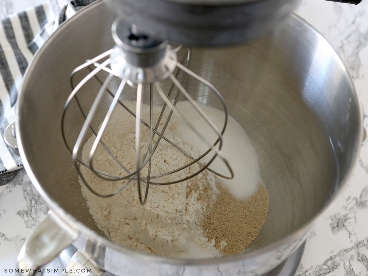 adding ingredients for sweet rolls to a mixer