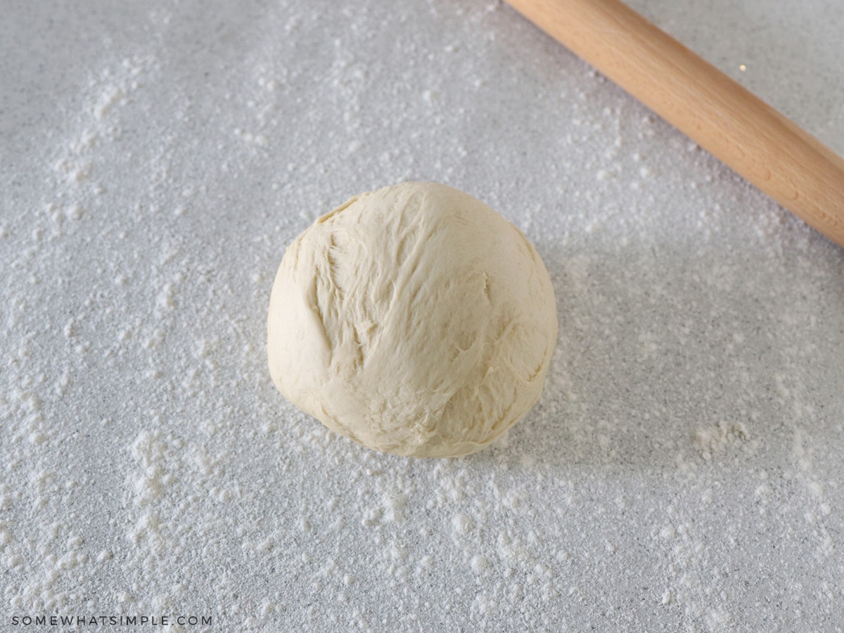 ball of dough on a floured surface